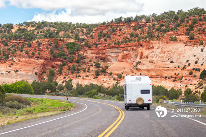 White Colour Motorhome Car Goes On Road with Background Of Mountains