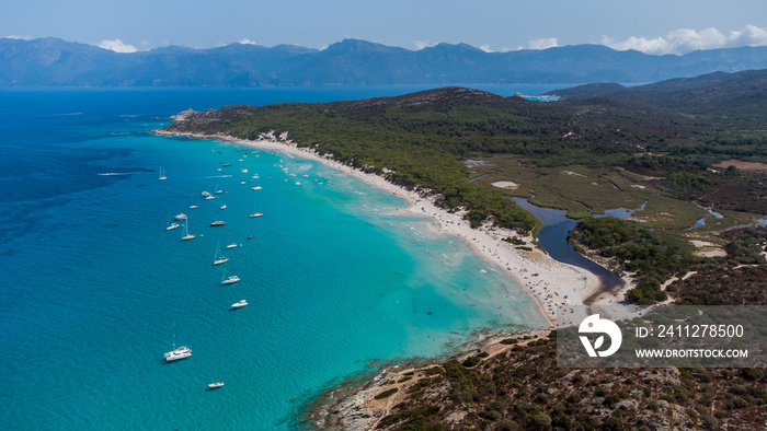 Aerial view of Saleccia Beach in the Agriates desert in Upper Corsica, France - Paradise beach in the Mediterranean Sea with tropical waters, only accessible by boat