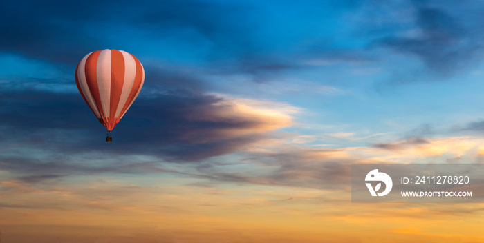 Colorful hot air balloons flying on the sunset sky background.