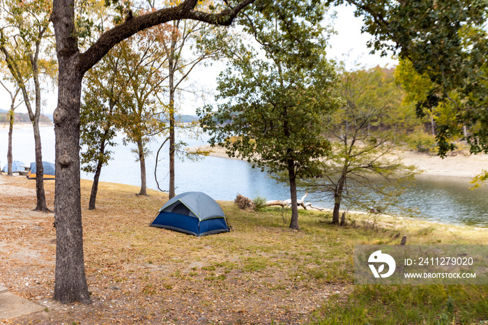 Camping tents near a beautiful lake among trees, campsite, adventure vacation concept, Broken bow lake in Oklahoma, USA.