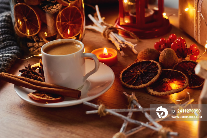 Cup of coffee in festive decorations with a fairy garland lights
