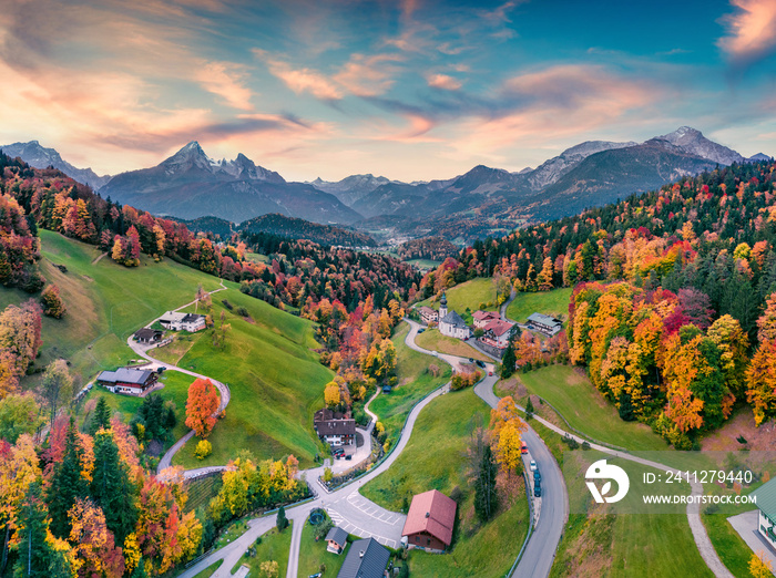 Fantastic evening view from flying drone of Maria Gern church with Hochkalter peak on background. Incredible autumn scene of Bavarian Alps. Colorful landscape of Germany countryside.