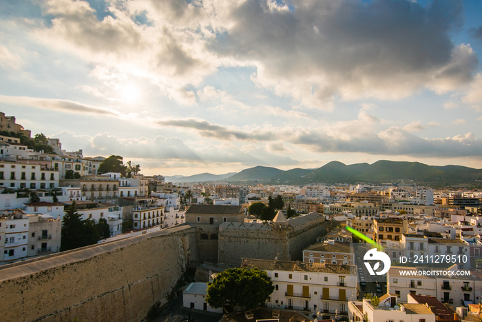 View from the top of Dalt Vila, Ibiza city center, and hills at the back, beautiful day with a blue sky and clouds