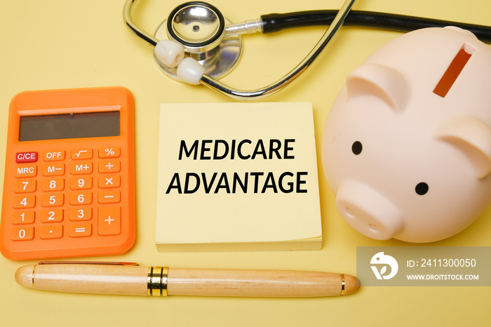 Selective focus of piggy bank and Medicare Advantage word with other item insight. Medicare Advantage Plan concept