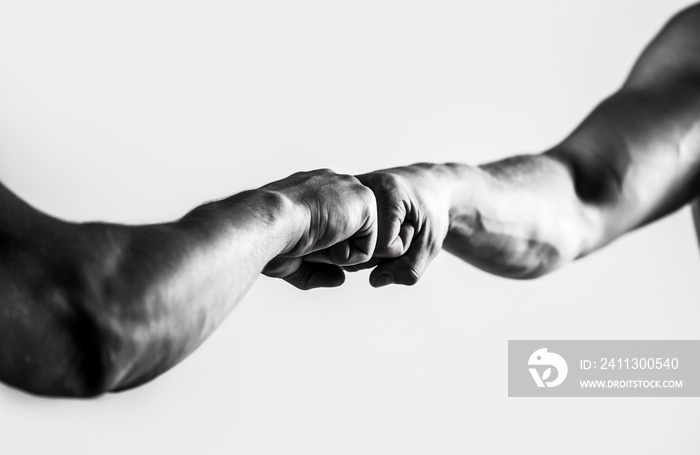 Friendly handshake, friends greeting. Hands of man people fist bump team teamwork, success. Man giving fist bump. People bumping their fists together, arms. Black and white