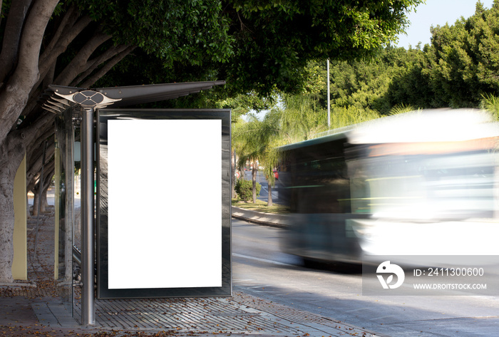 White blank vertical billboard at the bus stop on the city street. Sign on the street by the side of the road