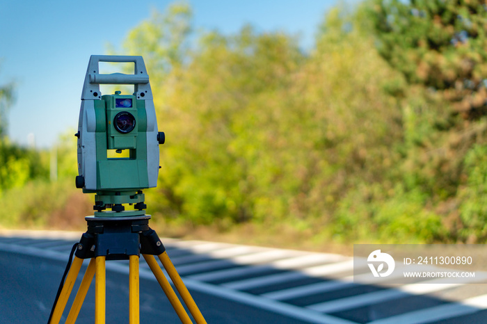 Surveyor equipment (theodolit or total positioning station) on the construction site of the motorway or road