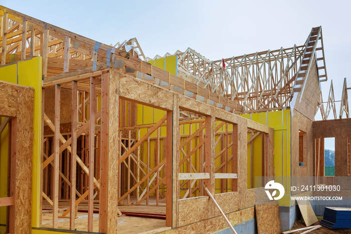 Installation of wooden beams at construction of frame house photo of a new home under construction