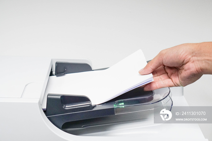 businessman is printing, copying and scanning the documents
