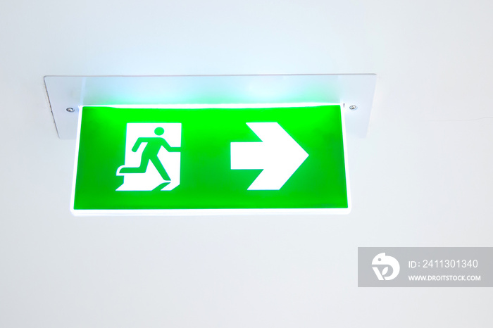 Green emergency fire exit sign or fire escape with the doorway in the building Ideas for evacuation drills in the event of a fire.