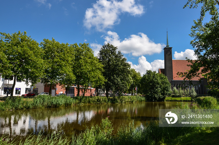 A lake in a park, next to the  Westsingel street and the Westerkerk church, in Goes, Netherlands