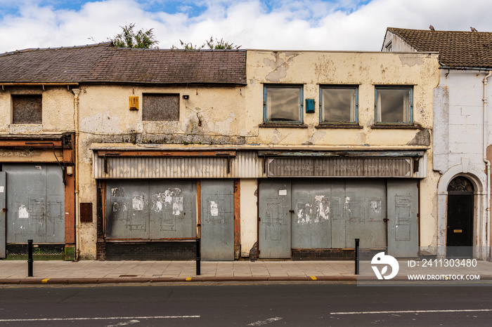 A rundown house with covered doors and windows in the ground floor, seen in Carlisle, Cumbria, England, UK