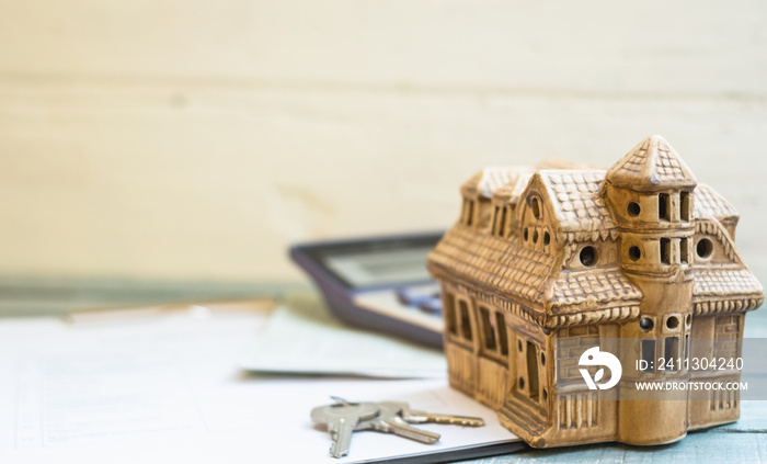 Home load and real real state investment. Loan application form, house model, calculator, book bank record  and keys on blue white wooden background.