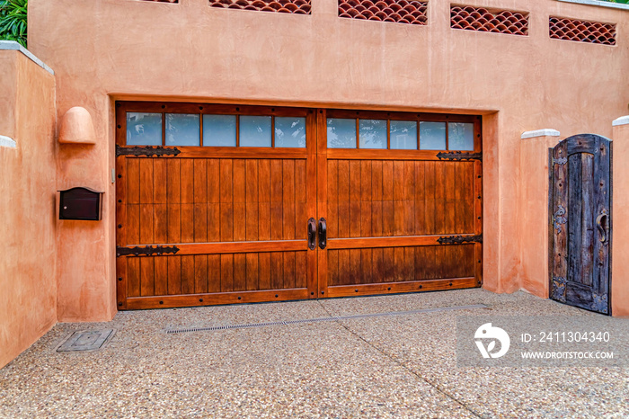 Brown wood door of garage with glass panes of home in San Diego CA neighborhood