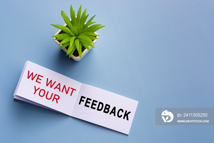 Text on notepad with reading glasses and potted plant on blue background