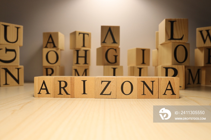 The word Arizona was created from wooden letter cubes. Cities and words.