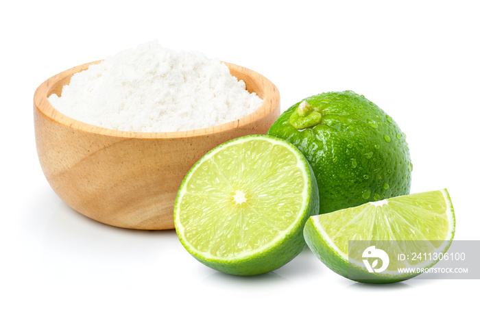 Lime powder in wooden bowl and fresh limes fruit isolated on white background.