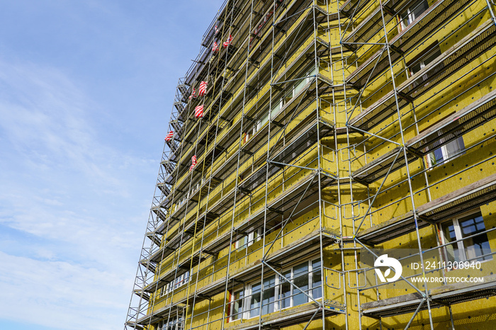 scaffolding arround the house to install thermal insulation of the apartment building facade