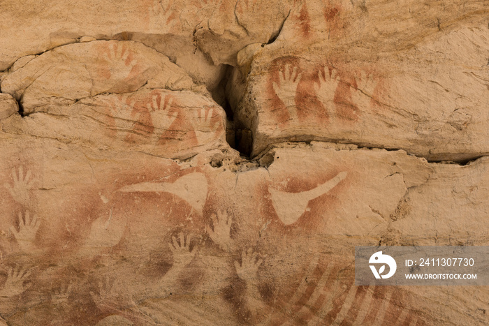 Aboriginal stencil rock art of hands and stone axes at Cathedral Cave, Carnarvon Gorge, Queensland, Australia.