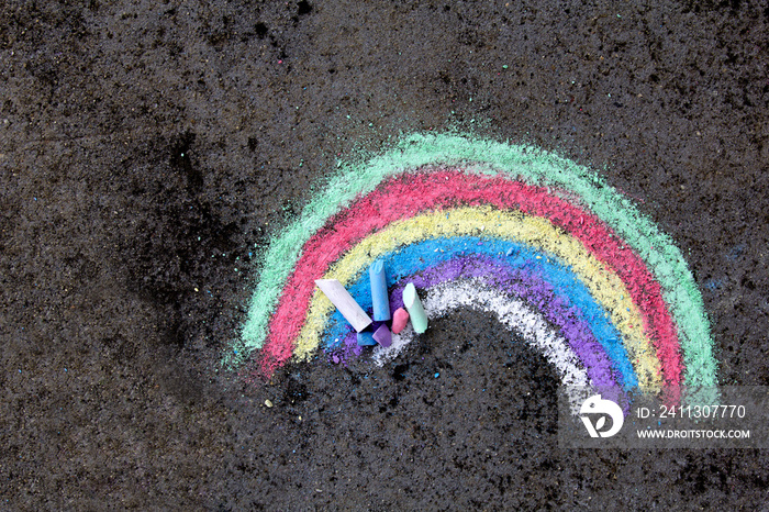 chalk drawing on asphalt: colorful rainbow