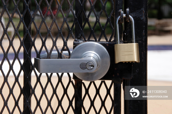 A the gate of a community pool in a public park locked as a precaution against the spread of the coronavirus