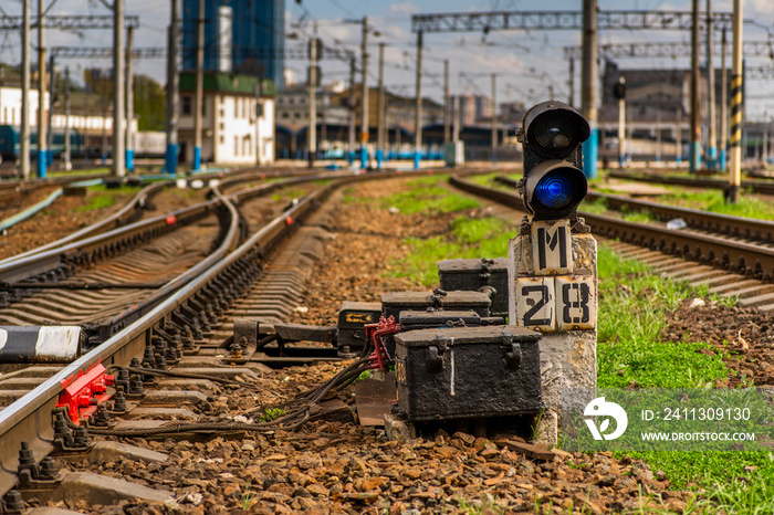 blue signal of the semaphore on the background of the railway track