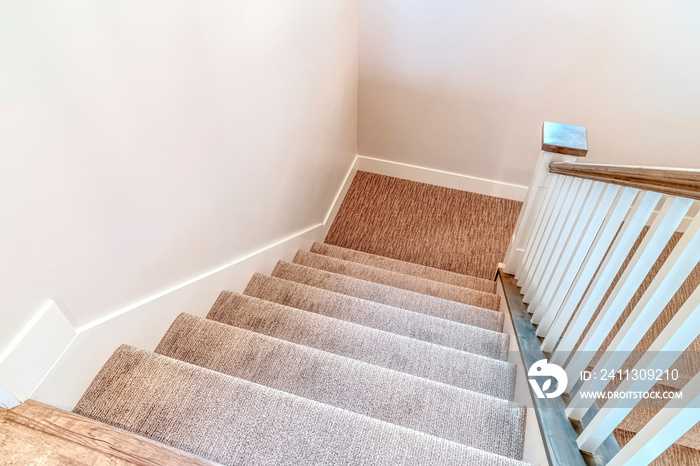 Interior staircase with U shape design that leads to the basement of a home