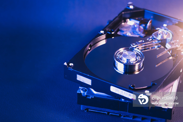 The abstract image of inside of hard disk drive on the technician’s desk and a computer motherboard as a component. the concept of data, hardware, and information technology.