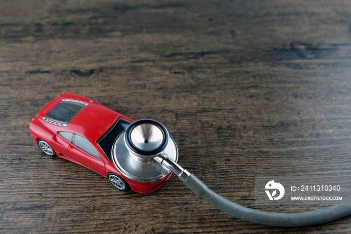 Stethoscope and car on the wooden table, Concept of car check-up, repair and maintenance..