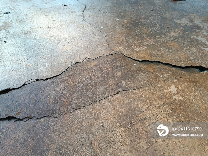 Cracked concrete ground broken at floor home or street road subside from earthquake