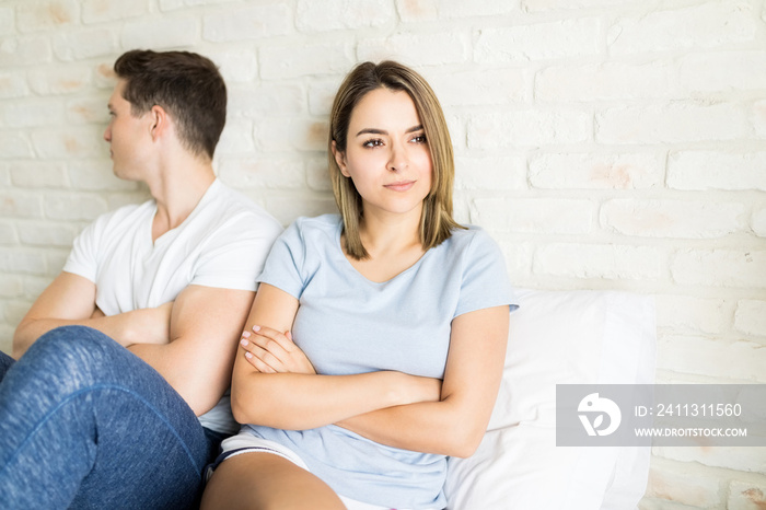 Bothered Woman Looking Away By Boyfriend On Bed