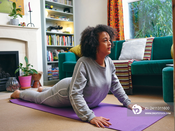 Woman practicing yoga at home