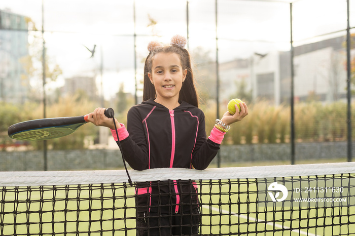 little Girl playing paddle tennis