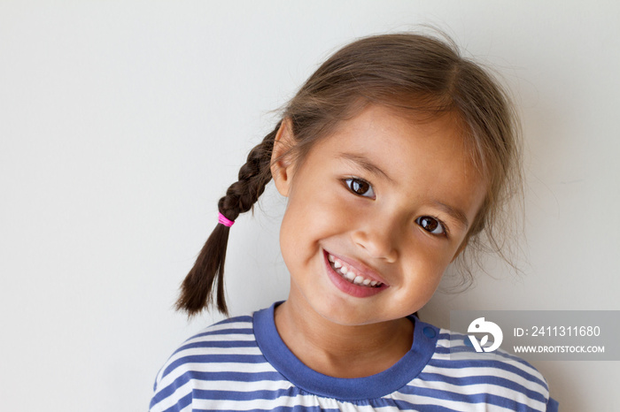 portrait of happy, positive, smiling, playful asian caucasian girl