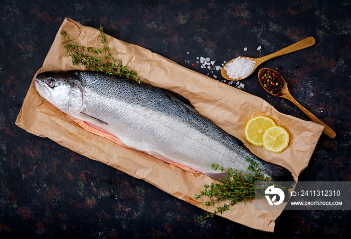 Fresh raw salmon red fish on a dark background. Flat lay. Top view