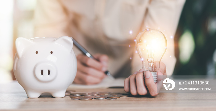 financial concept and saving money,investment savings,Planning savings for the future,retirement fund,financial preparation,future risk management,Man holding a light bulb and piggy bank on the table
