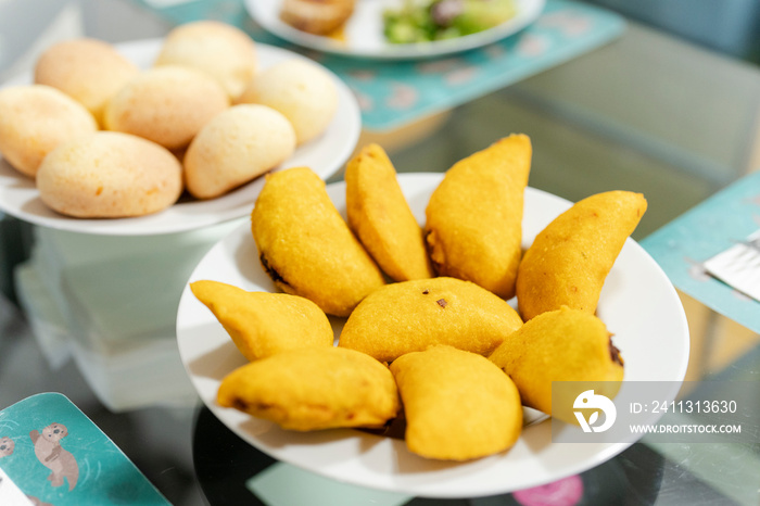 Plate of fresh empanadas on dining table