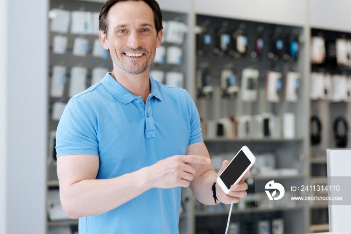 Smiling adult customer posing with phone mockup template for camera