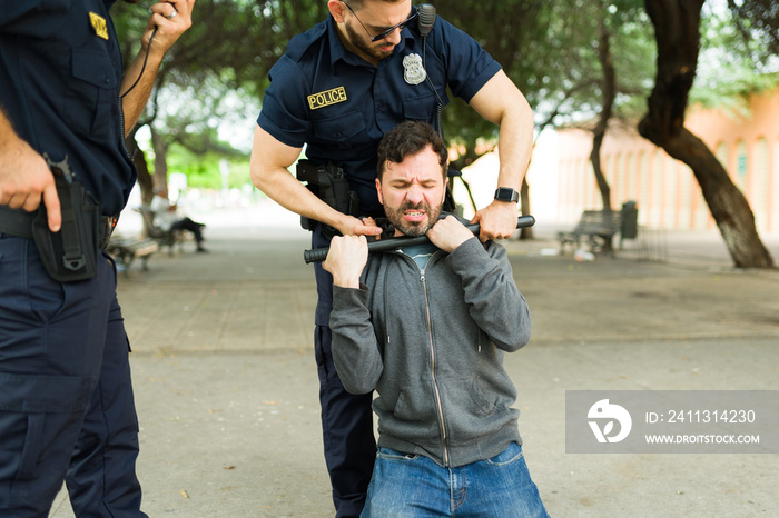 Police officers arresting a man after a crime