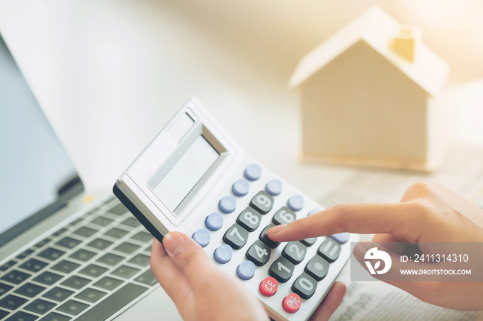 Woman accountant or bank worker uses calculator.