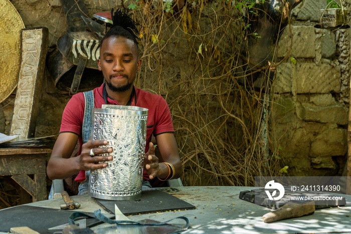 young man working on an aluminium sheet