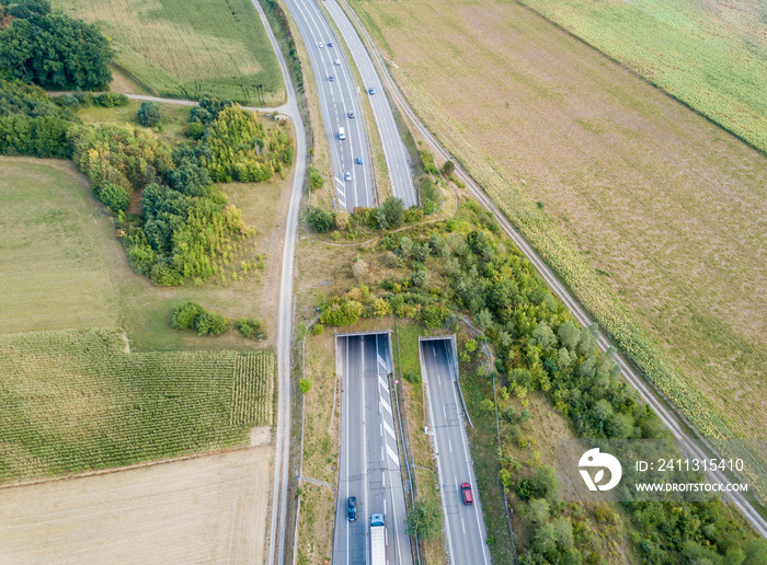 Aerial view of wildlife overpass over highway in Switzerland during sunset