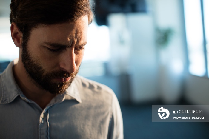 Upset businessman looking down