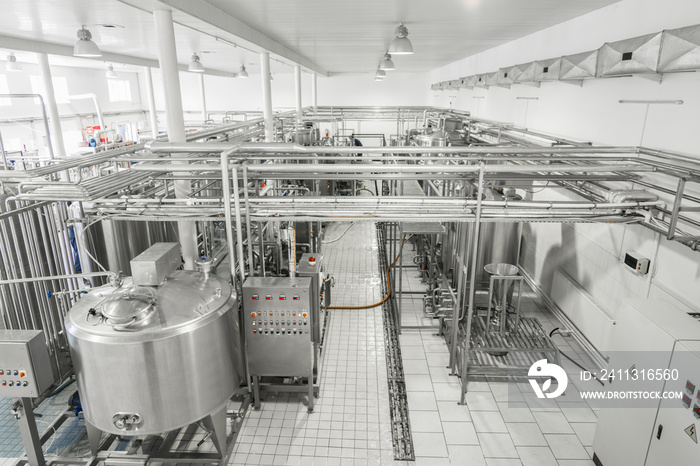 general view of the interior of a milk factory. equipment at the dairy plant