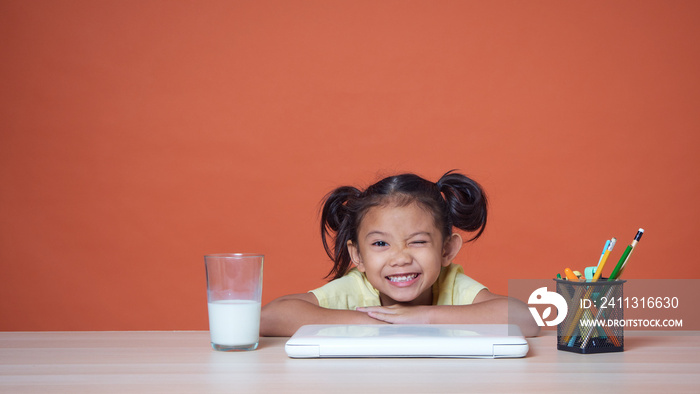 Little girl studying with laptop