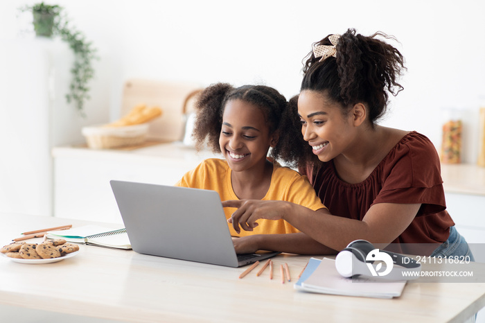 Creative black mother and daughter working on school project