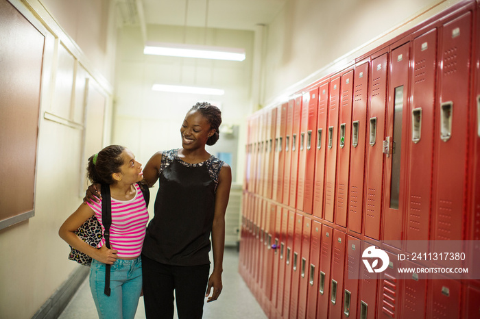 Female teacher and schoolgirl (16-17) in locker room