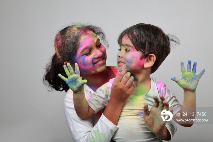 Little boy and girl play with Holi festival colours.Concept for Indian festival Holi