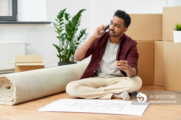 man with blueprint and boxes moving to new home