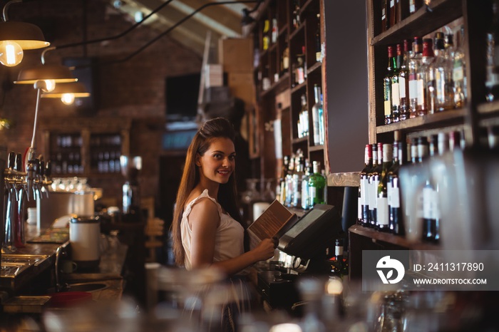 Female bar tender holding menu